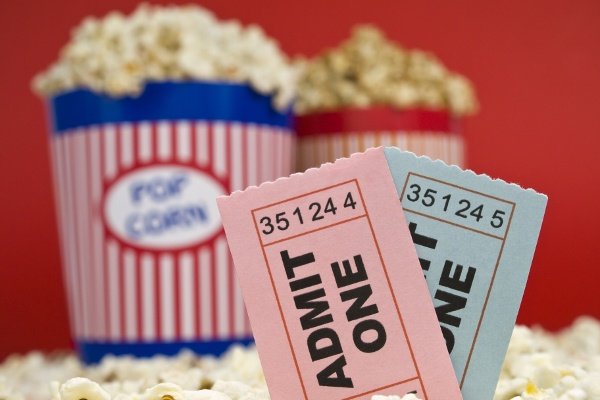 Movie Stub Two Sticking Out Of Popcorn With Two Pop Corn Bags In Background With Red Backdrop 1 Movie Stub Two Sticking Out Of Popcorn With Two Pop Corn Bags In Background With Red Backdrop 1